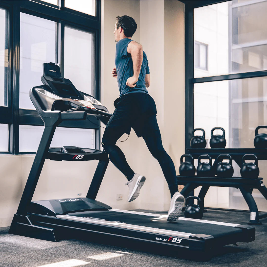Man running on a SOLE fitness treadmill.