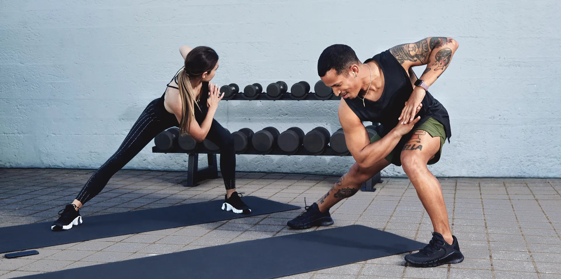 Nike training club, with a woman and a man in a gym setting.