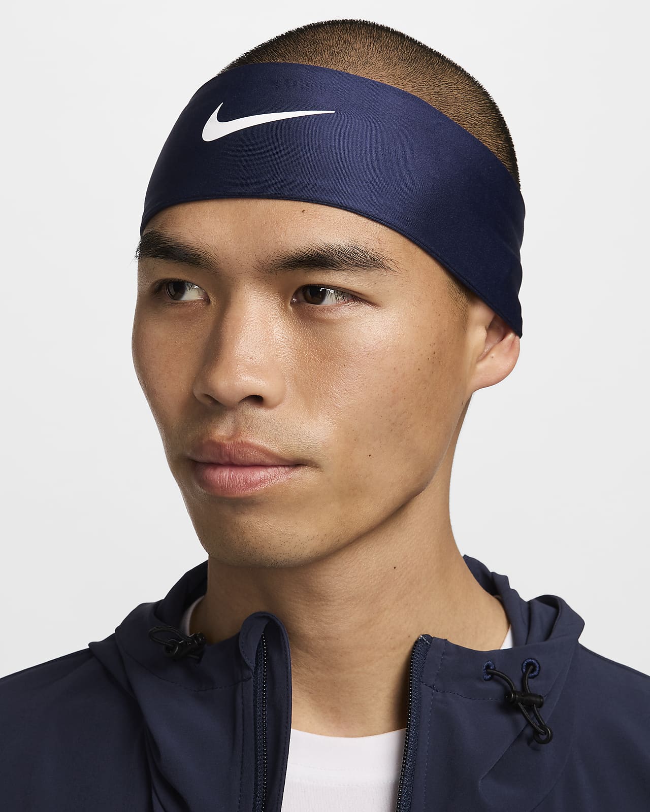A portrait photo for Nike accessories - a sweat headband worn by a man.