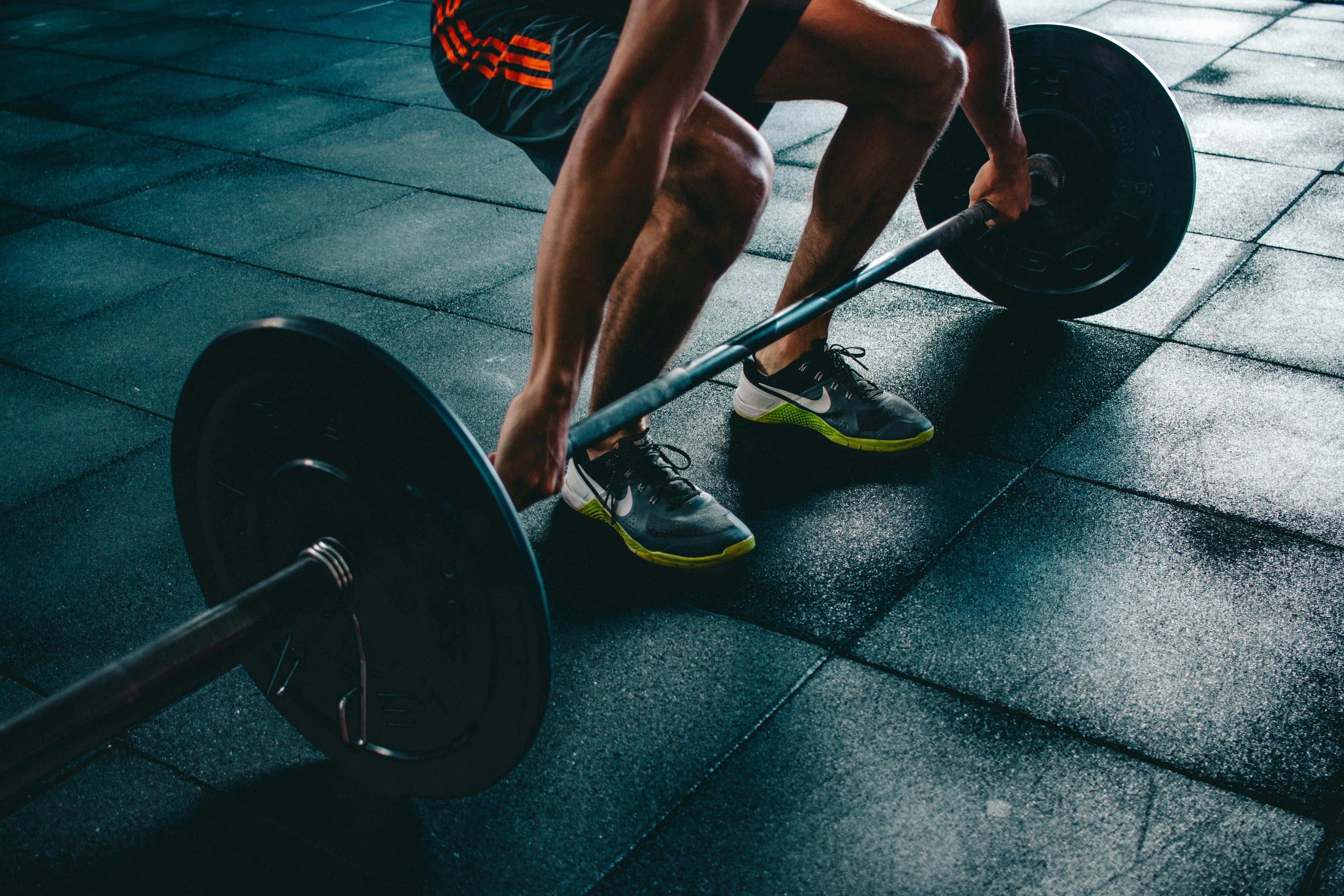 A man about to lift a weight bar.